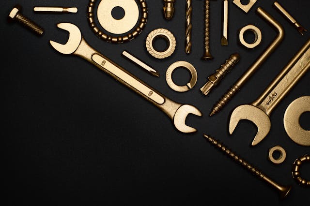 a bunch go wrenches and tools against a black background